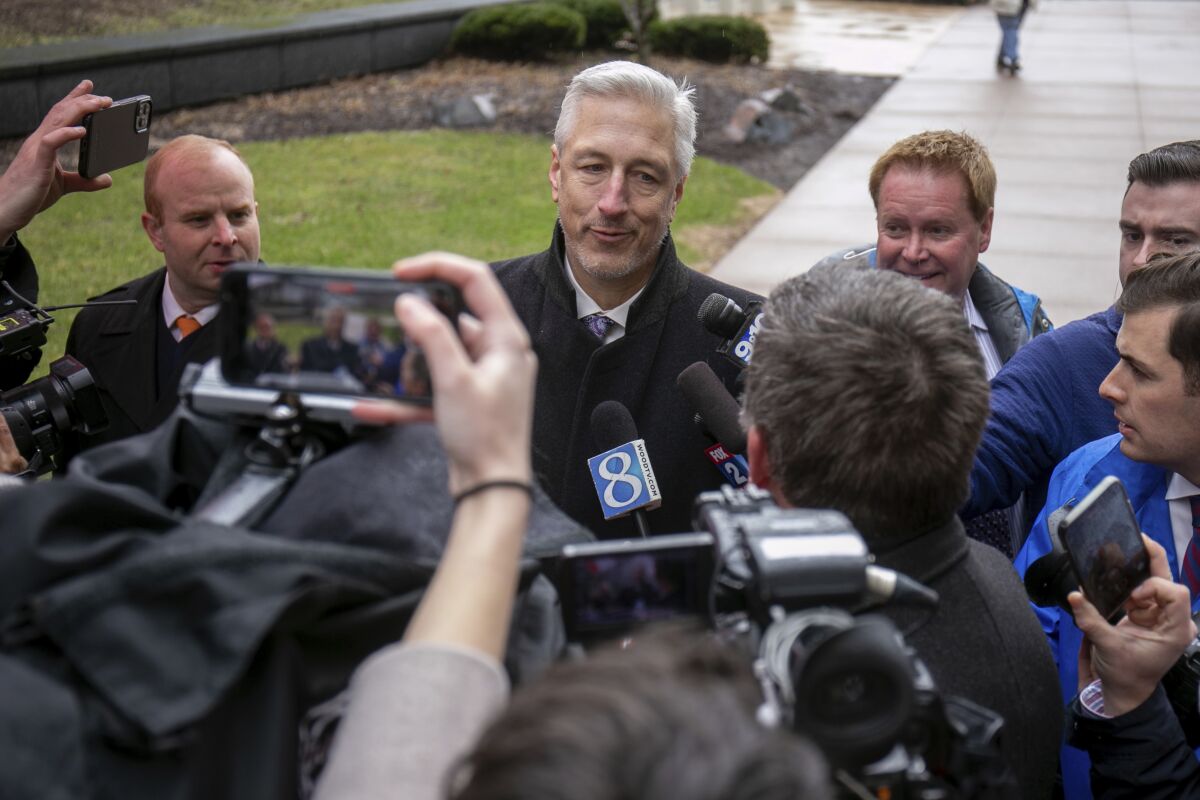 Michael Hills, the defense attorney representing Brandon Caserta, speaks to a scrum of reporters after Casterta was found not guilty of conspiring to kidnap and weapons charges outside the Gerald R. Ford Federal Building and Courthouse in Grand Rapids, Mich., Friday, April 8, 2022. Jurors have acquitted two defendants, Daniel Harris and Caserta, of all charges in a plot to kidnap Michigan Gov. Gretchen Whitmer but couldn't agree on a verdict for two others. (Daniel Shular/MLive.com/The Grand Rapids Press via AP)