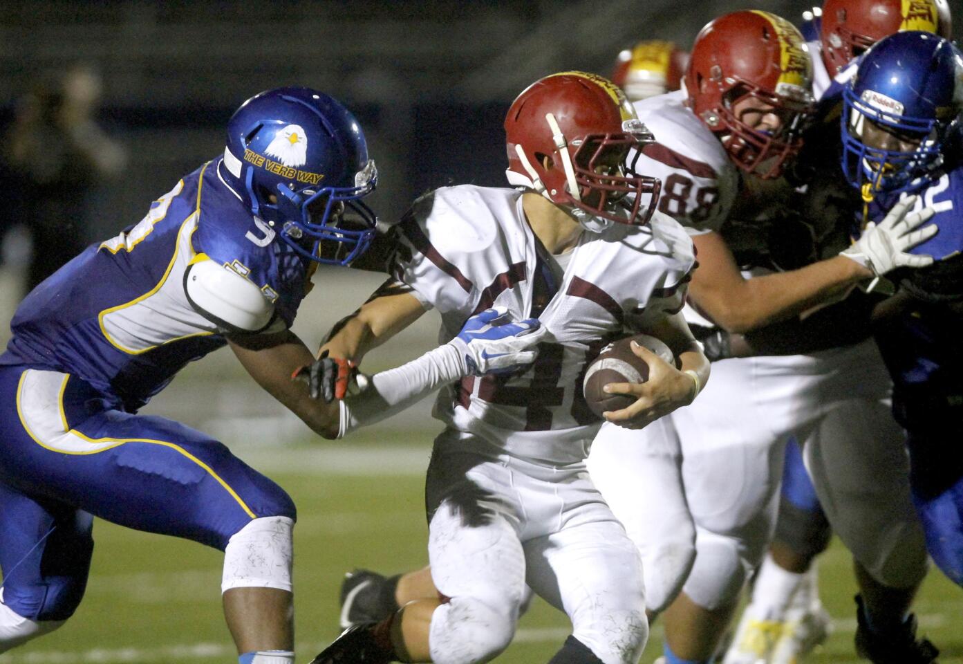 La Canada High School's #46 Ryan Breneman gets caught from behind by a Verbum Dei High School player during game at Los Angeles Southwest College in Los Angeles on Friday, Aug. 29, 2014.