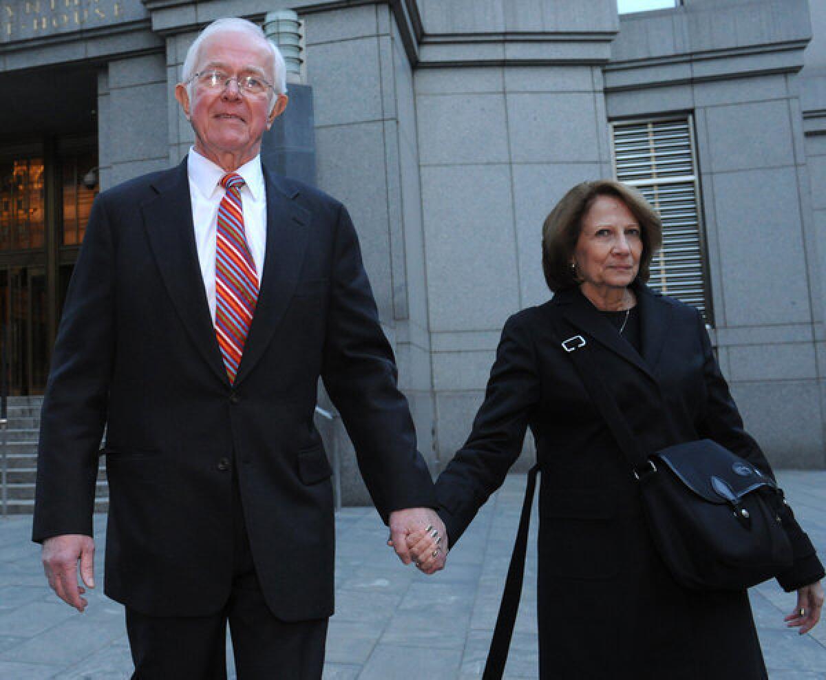 Bruce Bent Sr., left, exits Manhattan federal court with his wife after testifying at his fraud trial in October in New York.