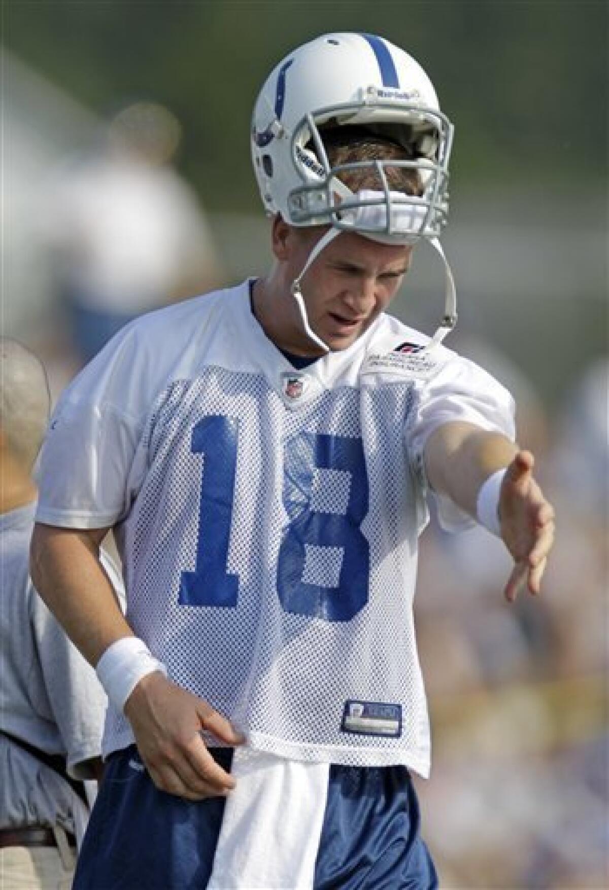 Why is Peyton Manning wearing his helmet in the training room? 