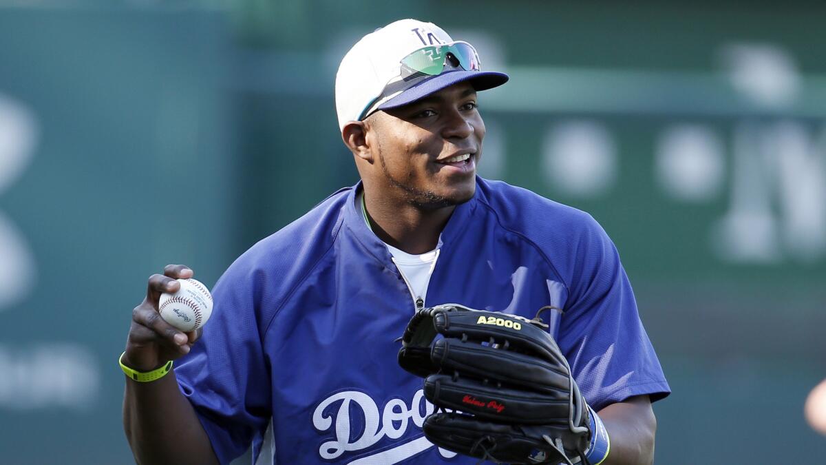 Dodgers right fielder Yasiel Puig smiles during batting practice prior to Tuesday's game against the Washington Nationals.
