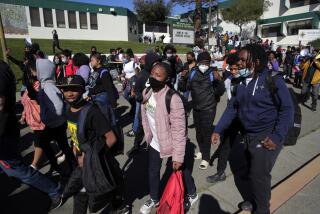 OAKLAND, CA - FEBRUARY 1: Students, teachers and parents demonstrate outside of Oakland Unified School District offices after they walked out of Westlake Middle School to protest its consideration for closure by the district in Oakland, Calif., on Tuesday, February 1, 2022. (Carlos Avila Gonzalez/San Francisco Chronicle via Getty Images)