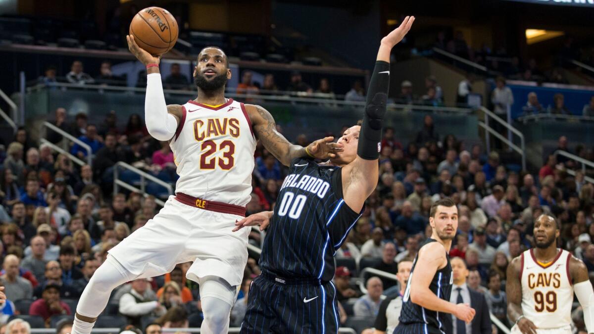 Cleveland Cavaliers forward LeBron James shoots over Orlando Magic forward Aaron Gordon during the first half.