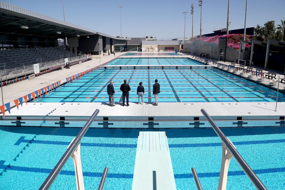 Guests tour a 65-meter competition pool and a 25-meter adaptive pool during a ribbon-cutting and dedication Tuesday at OCC. 