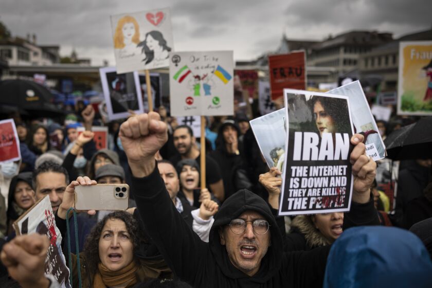 People protest against the death of Iranian Mahsa Amini, in Zurich, Switzerland, on Saturday Oct. 1, 2022. Amini, a 22-year-old woman who died in Iran while in police custody, was arrested by Iran's morality police for allegedly violating its strictly-enforced dress code. (Michael Buholzer/Keystone via AP)