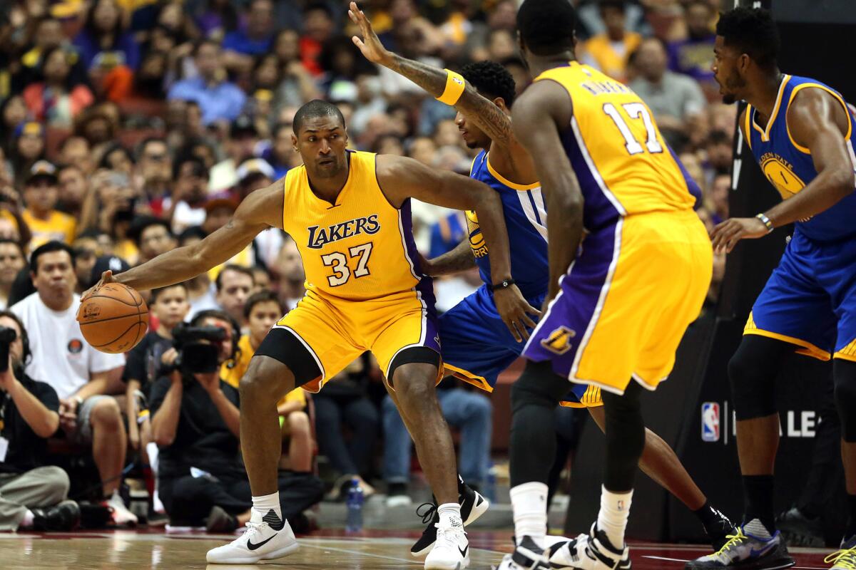 Lakers forward Metta World Peace works in the post against the Warriors during the fourth quarter of an exhibition game at Honda Center on Oct. 22.