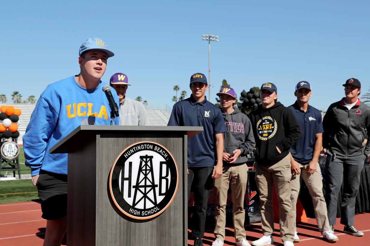 Baseball player Ben Jacobs, far left, introduces himself and what college he intends to commit to during winter signing day.