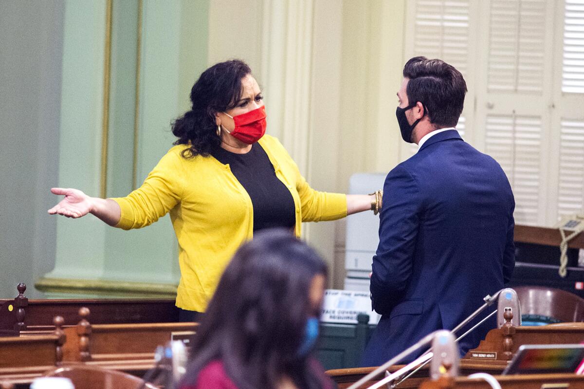 Assemblywoman Lorena Gonzalez (D-San Diego) talks with Assemblyman Ian Calderon (D-Whittier) on the Assembly floor,