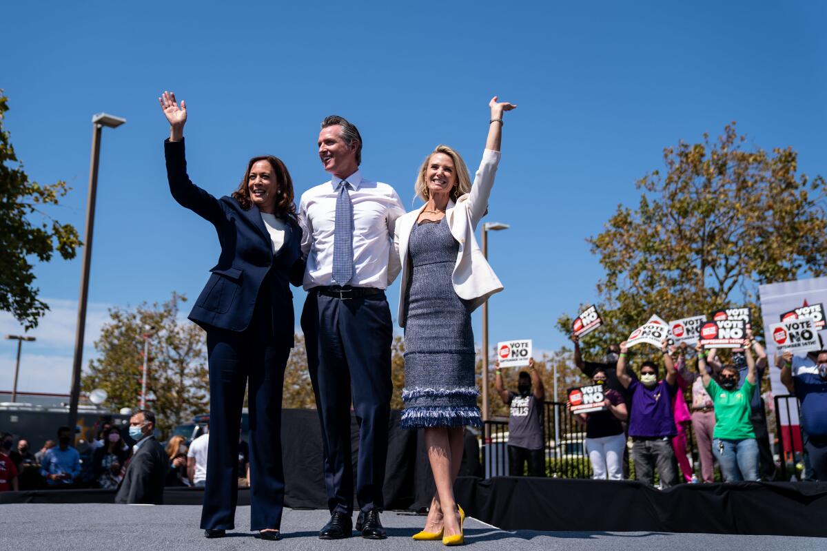 VP Kamala Harris, Gov. Gavin Newsroom and First Lady Jennifer Seibel-Newsom wave at a rally against the  recall election
