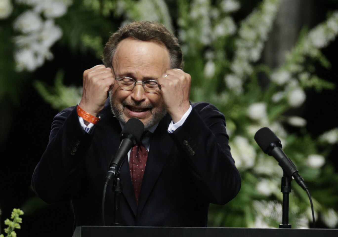 Comedian Billy Crystal imitates Muhammad Ali during the memorial service.