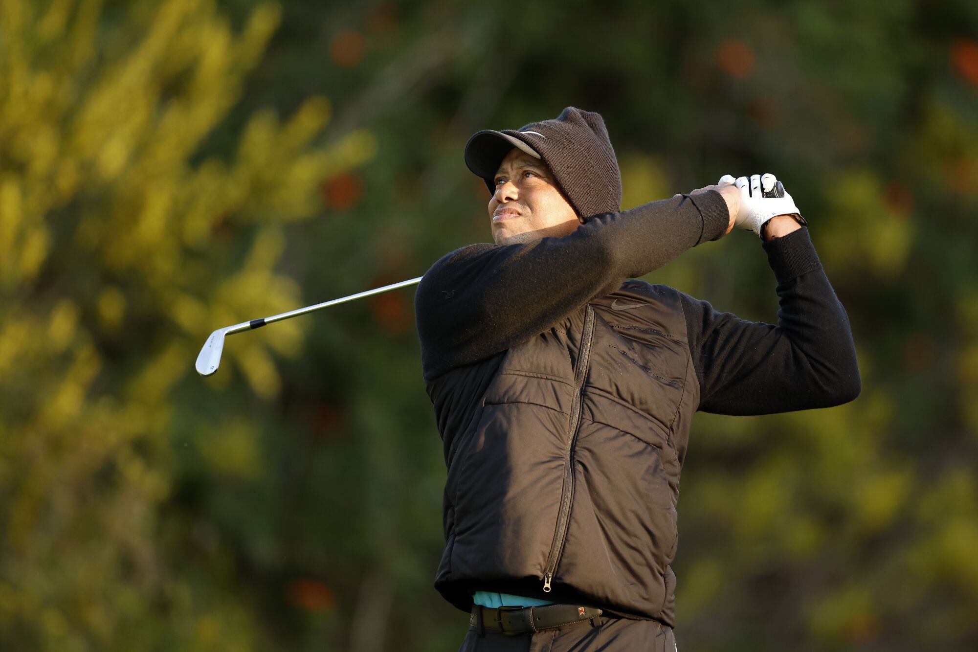 What's buzzing at Genesis Invitational: LIV Golf, Tiger Woods, favorites and sleepers Tiger Woods, bundled against the chill, follows through on a tee shot