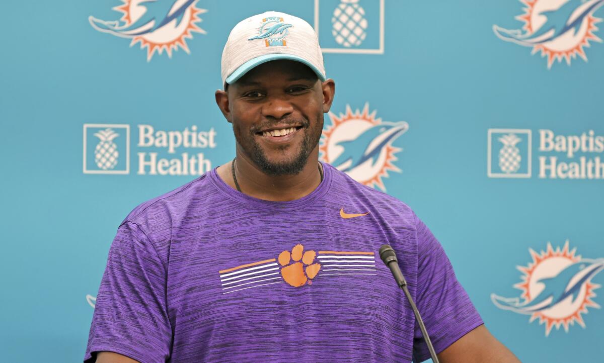 Miami Dolphins NFL football team head coach Brian Flores smiles while talking to the media before practice in Miami Gardens Fla., Wednesday, Oct. 13, 2021. The Dolphins play against the Jacksonville Jaguars in London on Sunday. (David Santiago/Miami Herald via AP)