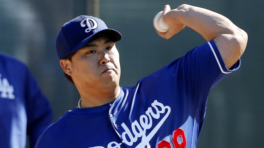 Dodgers starter Hyun-Jin Ryu, who is returning from shoulder surgery, throws in the bullpen on Feb. 26 at Camelback Ranch. He experienced soreness afterward and has not thrown since.