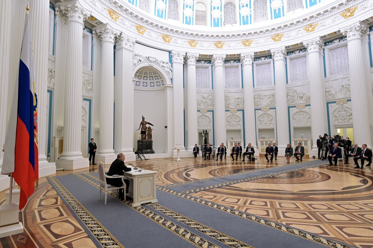 Russian President Vladimir Putin, left, chairs a Security Council meeting in the Kremlin in Moscow on Feb. 21, 2022.  