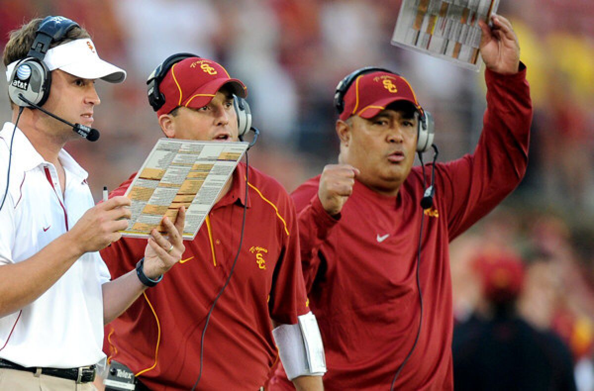 Kennedy Polamalu, right, was a key part of the staff for former USC coach Lane Kiffin, left.