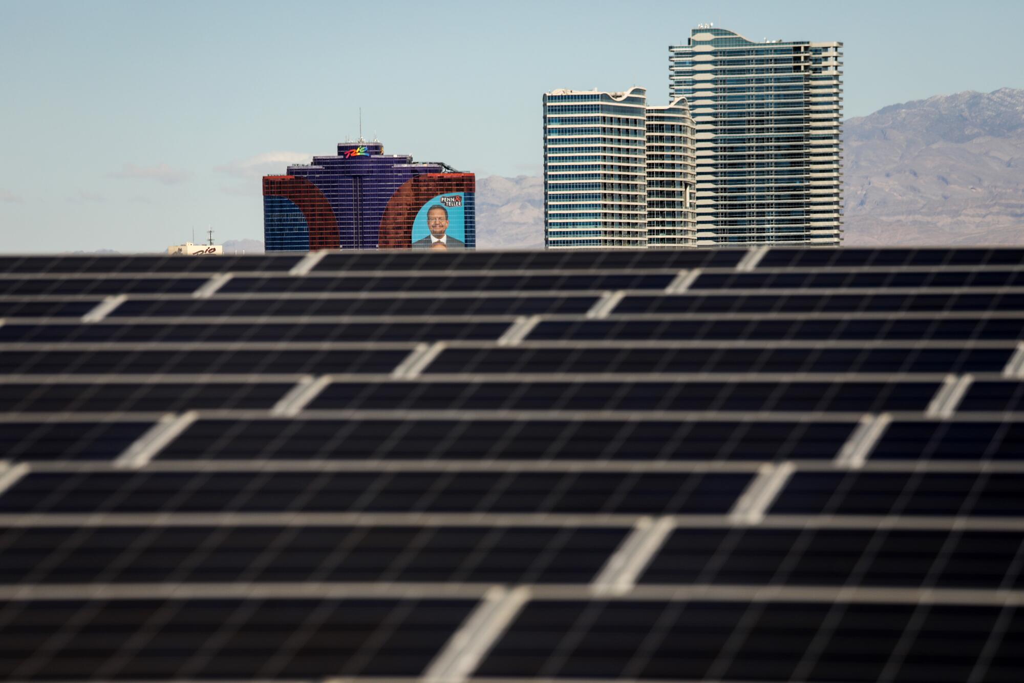 Solar panels on the roof of Mandalay Bay Convention Center, with Rio hotel and casino in the background.