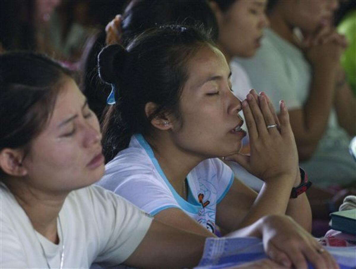 In this photo taken Tuesday, June 29, 2010, ethnic Karen women pray during a religious service near Mae La, Thailand. The Karen, an ethnic minority people of about 4 million within Myanmar's 43 million, are being pushed by the military from their homes in western Myanmar to the border with Thailand almost daily. Human rights groups and aid workers call it "the hidden Darfur." (AP Photo/David Longstreath)