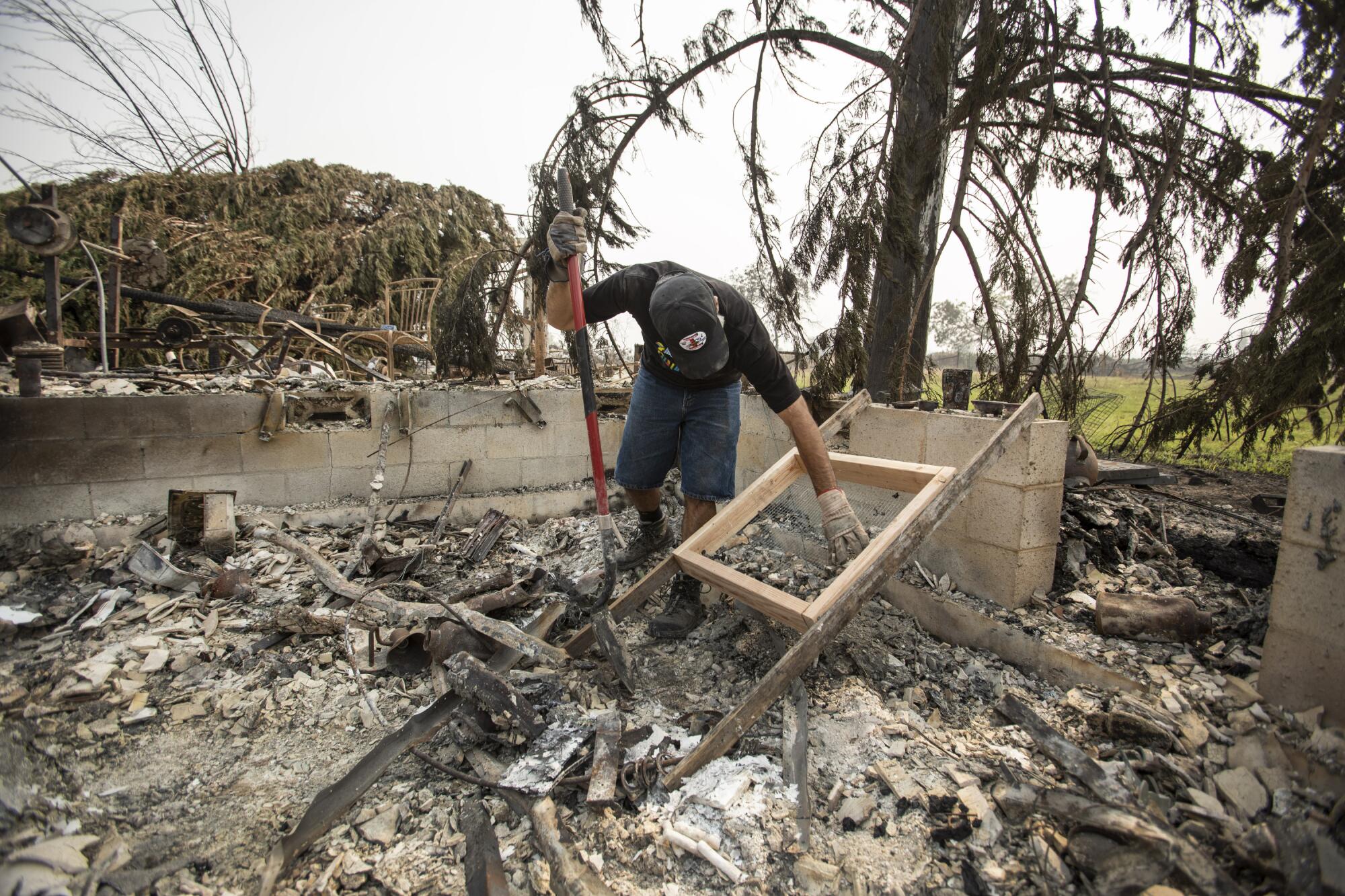 Fred Skaff, 52, of Phoenix, Ore., sifts through the remains of his home, looking for his wedding.
