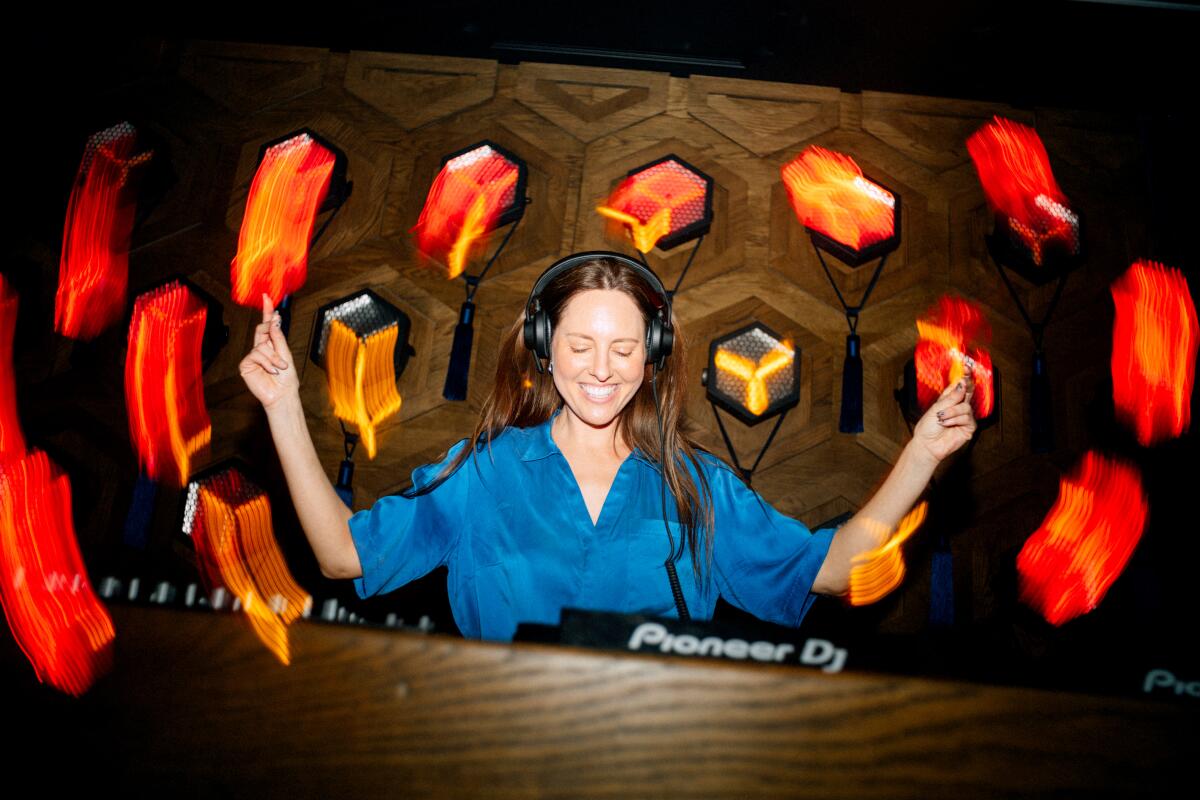 Female DJ in a blue shirt