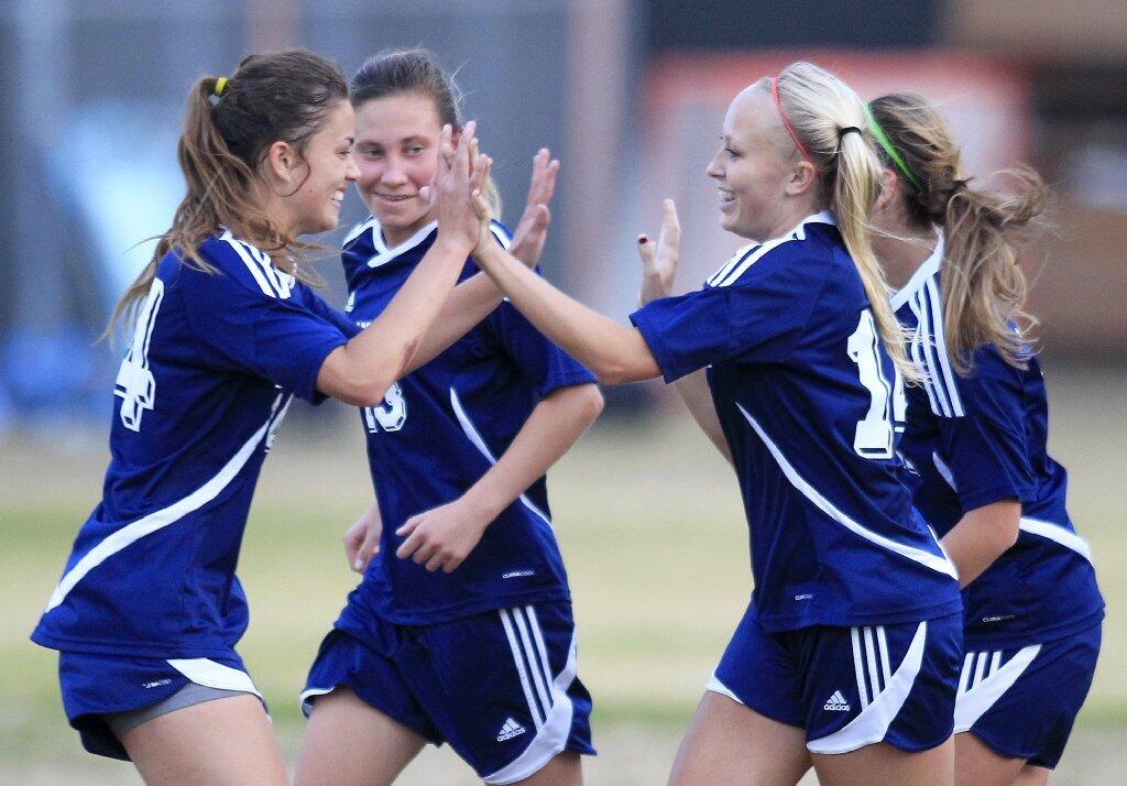 Newport Harbor High's Jessica Prather, second from right, celebrates with teammates Sianna Siemonsma, far left, Toni Holland, second from left, and Allyson Nordlie, far right, after scoring on a penalty kick during the second half against Corona del Mar in the Battle of the Bay match on Tuesday.