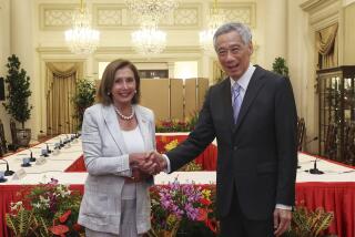 In this photo provided by Ministry of Communications and Information, Singapore, U.S. House Speaker Nancy Pelosi, left, and Prime Minister Lee Hsien Loong shake hands at the Istana Presidential Palace in Singapore, Monday, Aug. 1, 2022. Pelosi arrived in Singapore early Monday, kicking off her Asian tour as questions swirled over a possible stop in Taiwan that has fueled tension with Beijing. (Ministry of Communications and Information, Singapore via AP)
