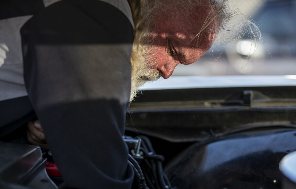 Joe Miracle, 70, works Thursday on a 1970 Chevy Impala at his store, Bay Auto Service in Costa Mesa.