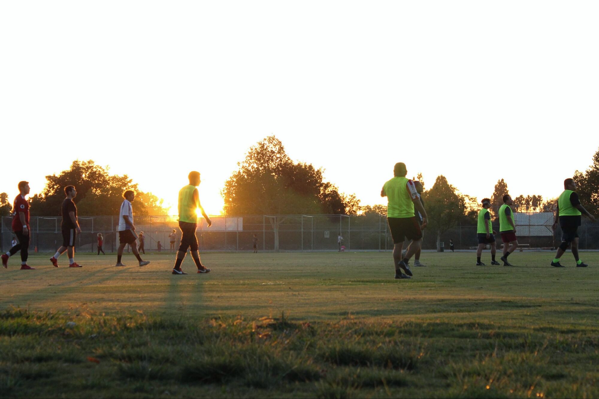 The sun sets on the horizon as the players wrap up their game. Photos by Adria Marin, a student with Las Fotos.