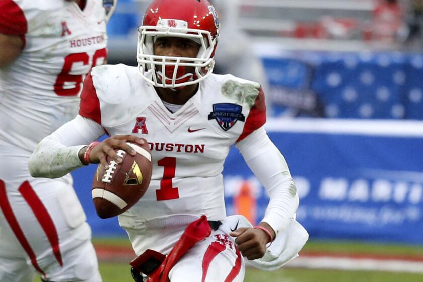 Houston quarterback Greg Ward, scrambling in the second quarter, threw three touchdown passes in the final 3:41 to lift the Cougars to a win in the Armed Forces Bowl.