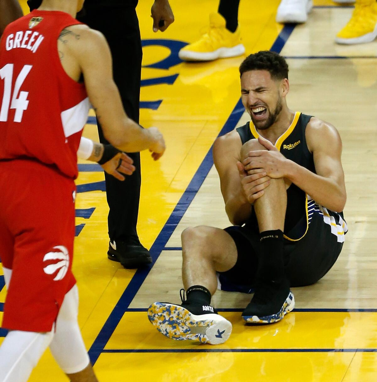 Golden State's Klay Thompson clutches his knee after landing awkwardly in the second half of Game Six of the NBA Finals on Thursday night in Oakland. Thompson suffered a torn ligament, the team announced later.