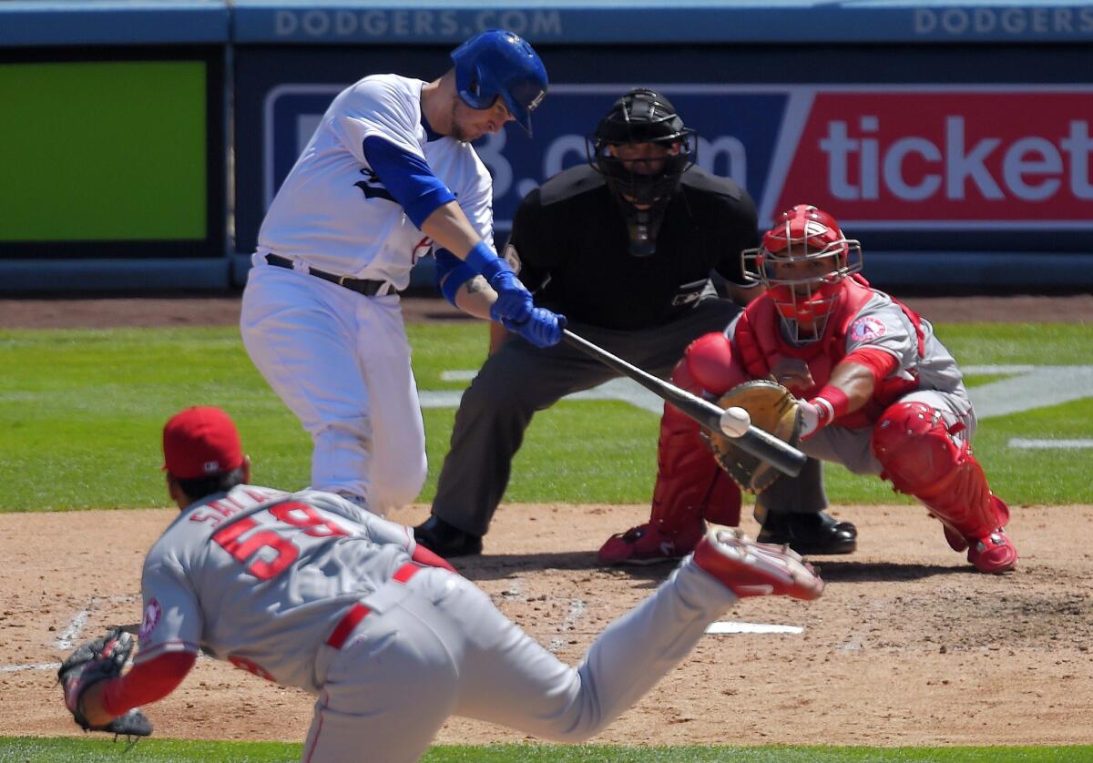 Dodgers catcher Yasmani Grandal hits a two-run home run against Angels relief pitcher Fernando Salas in the sixth inning.