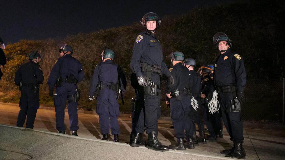 A new report looks at the number of law enforcement officers killed in the line of duty in 2014. Above, Los Angeles police at an Ezell Ford demonstration Monday on the 110 Freeway.