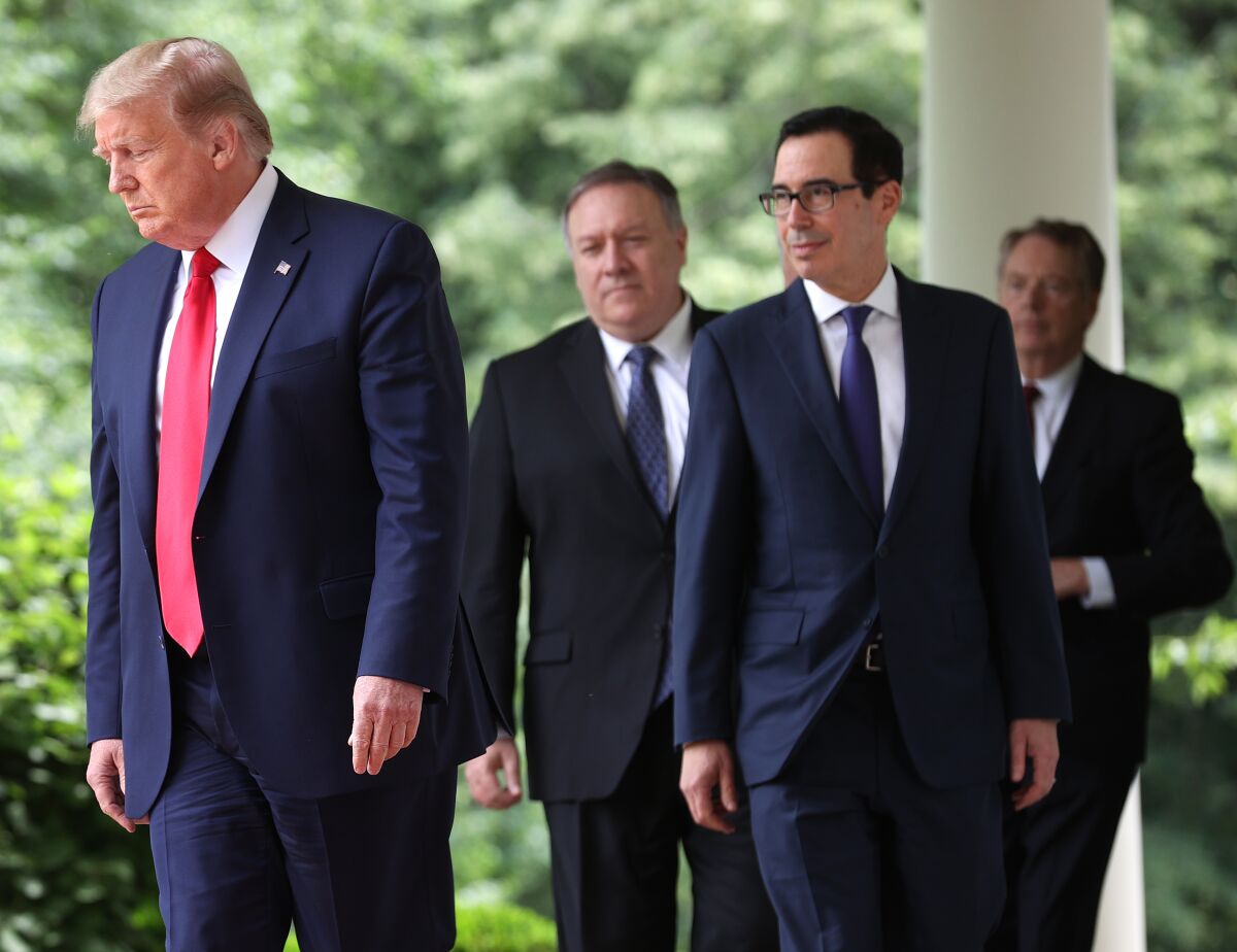 President Trump, left, Michael R. Pompeo, Steven T. Mnuchin and Robert Lighthizer walk to the White House Rose Garden May 29.