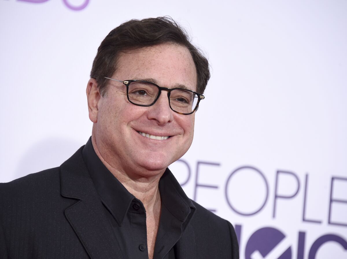 A smiling Bob Saget arrives at the People's Choice Awards