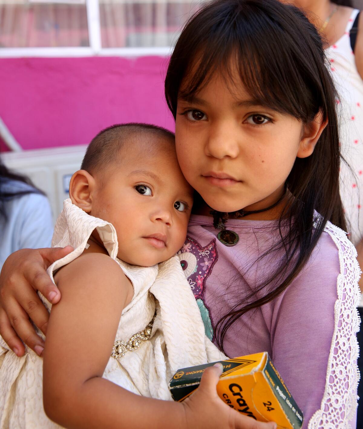 Ruby Esquivel Santana, 10, cradles Dalia Molina Chavez, 1