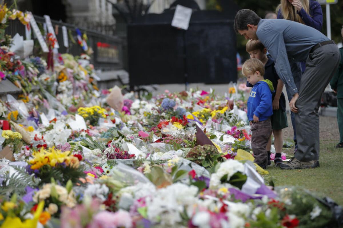 Mourners place flowers on a wall at the Botanical Gardens in Christchurch, New Zealand, on March 18.