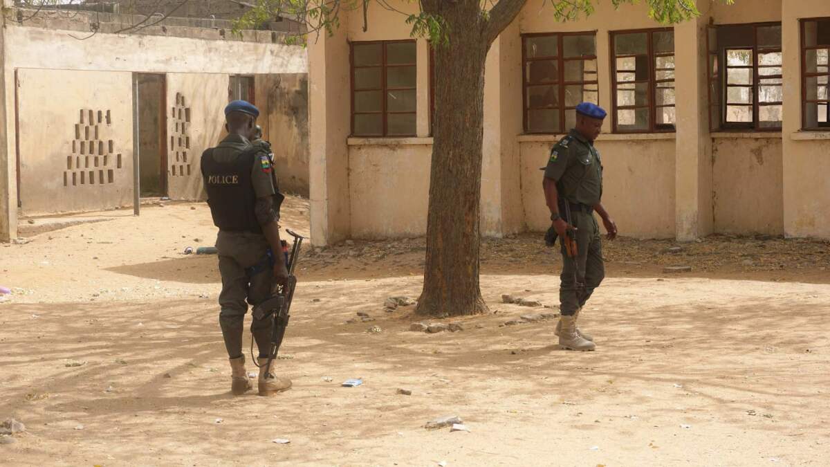 Police officers stand guard Feb. 28 at the Government Girls Technical College, where 110 girls were kidnapped by Boko Haram extremists.