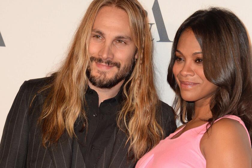 Zoe Saldana and Marco Perego arrive at a reception to celebrate the Oct. 1, 2014, opening of the multimedia exhibition "Hollywood Costume" in Los Angeles.