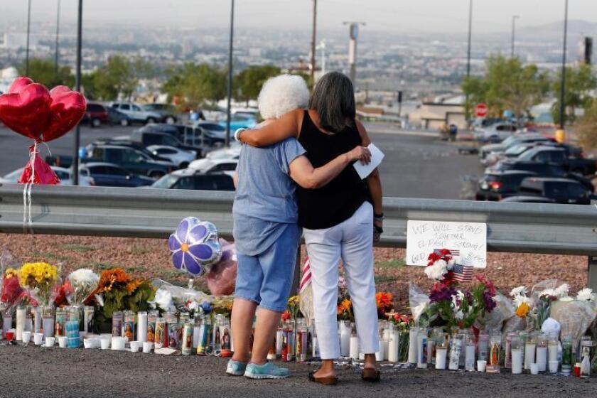 Emma Del Valle (L) hugs Brenda Castaneda (R) while attending the make shift memorial along the street after the mass shooting that happened at a Walmart in El Paso, Texas, USA, 05 August 2019. EFE/EPA/Larry W. Smith