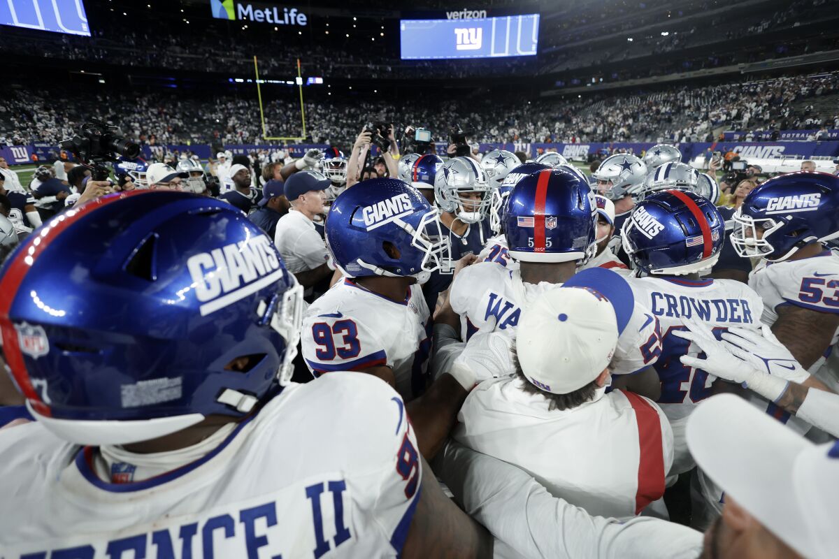 New York Giants and Dallas Cowboys players push and shove each other after an NFL football game, Monday, Sept. 26, 2022, in East Rutherford, N.J. (AP Photo/Adam Hunger)