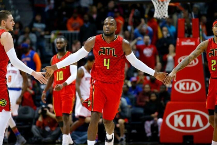 Hawks forward Paul Millsap (4) reacts with forward Mike Muscala (31) and forward Kent Bazemore (24) in the fourth overtime of a game against the Knicks on Jan. 29.