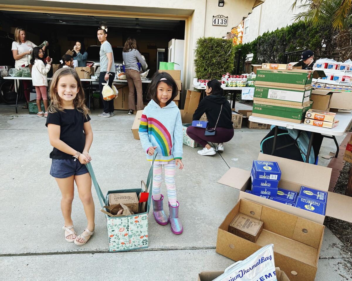 Young 92130 Cares volunteers helped pack Thanksgiving donations.