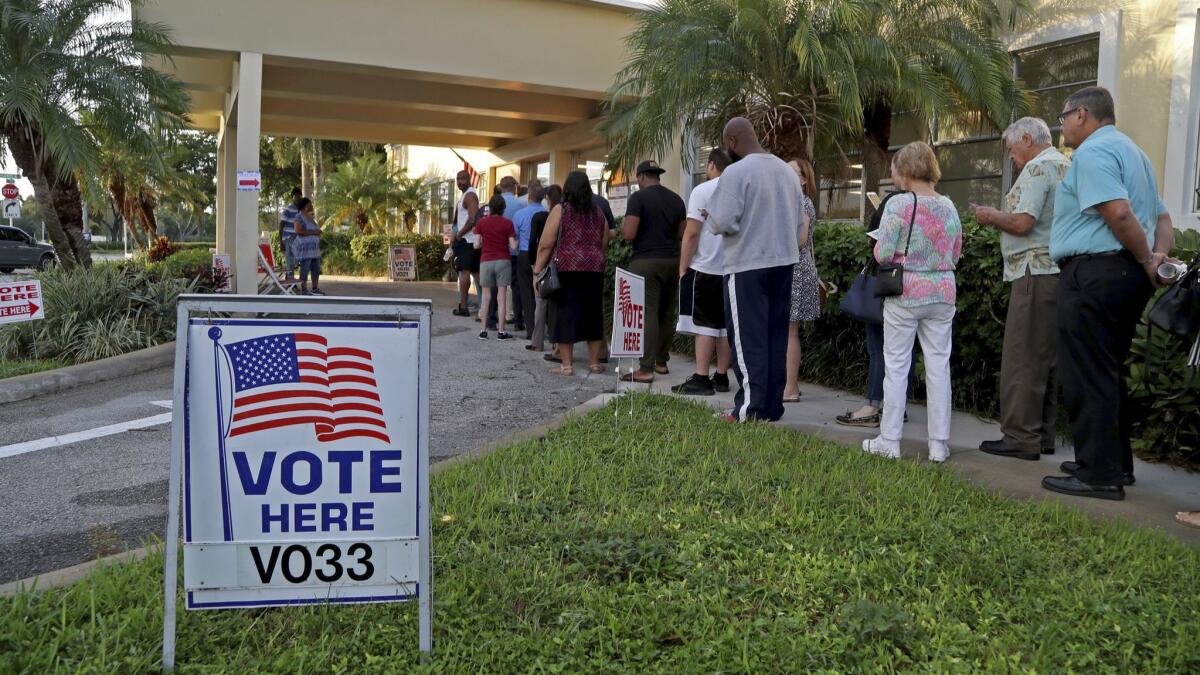 Voters line up as the polls open at David Park Community Center in Hollywood, Fla., on Nov. 6.