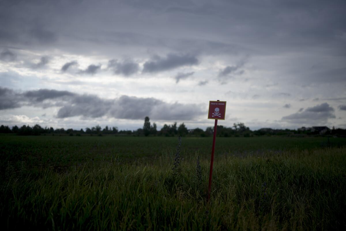 Sign in a field warning of mines