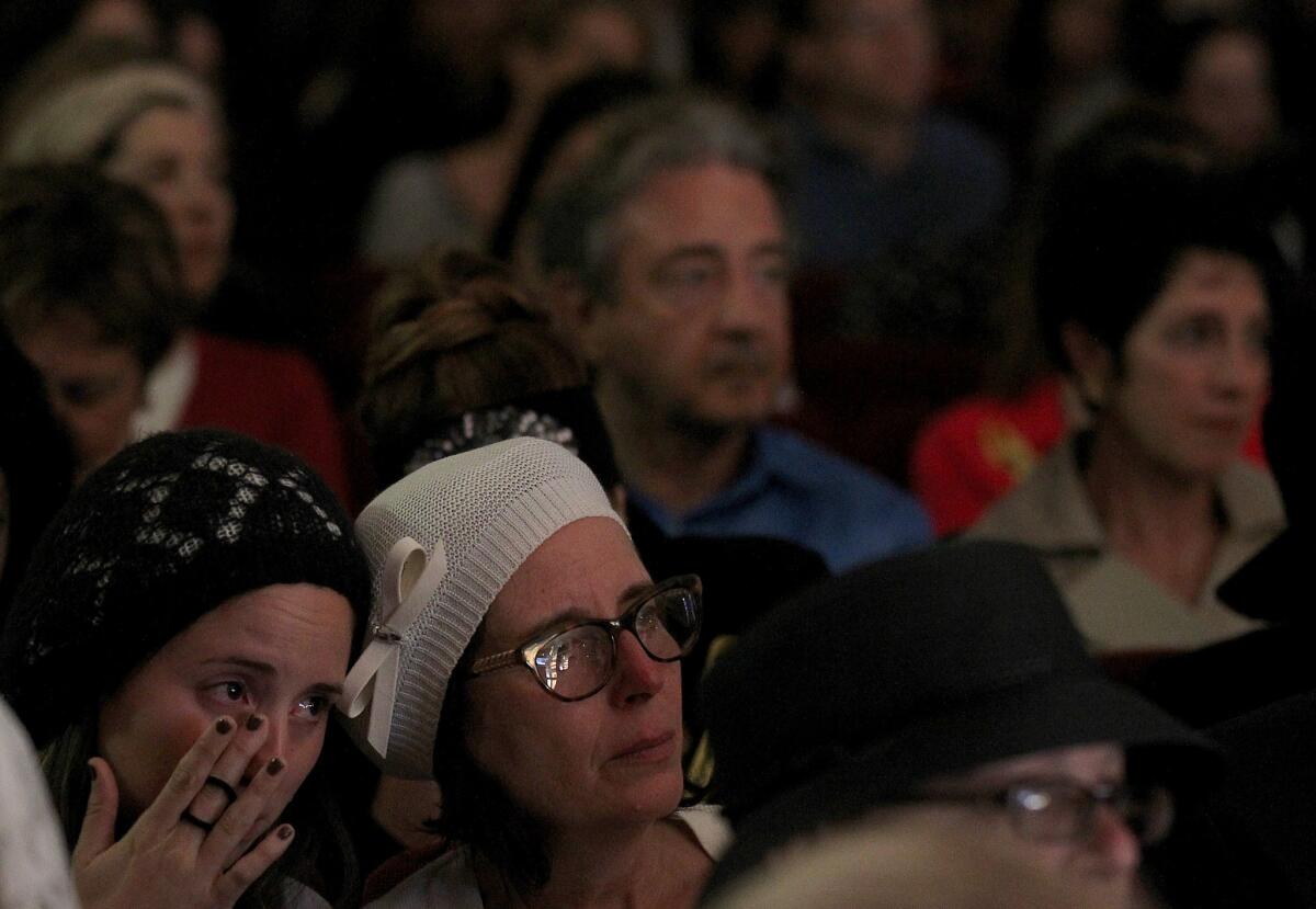 A mourner sheds tears for three slain Israeli teens at a memorial service Tuesday night in Beverly Hills.
