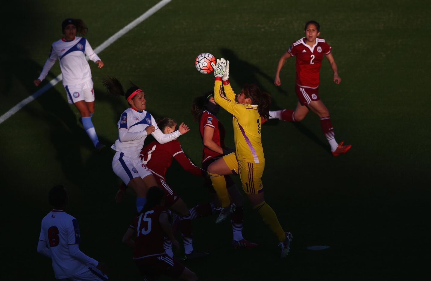 FRISCO, TX - FEBRUARY 10: Cecilia Santiago #1 of Mexico makes a save in front of Karina Socarras #9 of Puerto Rico during 2016 CONCACAF Women's Olympic Qualifying at Toyota Stadium on February 10, 2016 in Frisco, Texas. (Photo by Ronald Martinez/Getty Images) ** OUTS - ELSENT, FPG, CM - OUTS * NM, PH, VA if sourced by CT, LA or MoD **
