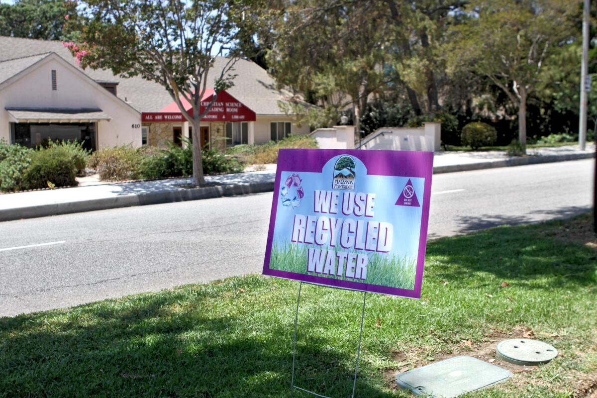 There are multiple signs like this one spaced out along the center median on Foothill Boulevard, proclaiming the city of La Cañada Flintridge uses recycled water to irrigate the public lawns.