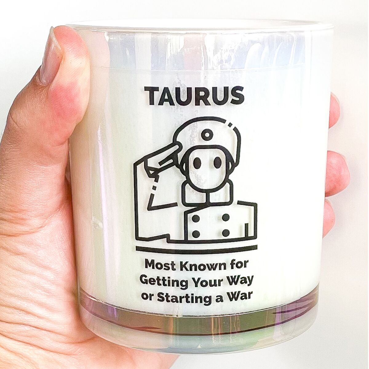 A candle that says "Taurus: Most Known for Getting Your Way or Starting a War"