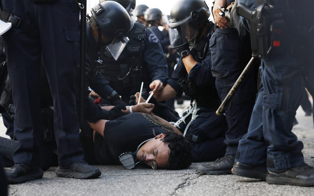 Los Angeles police officers arrest a protester