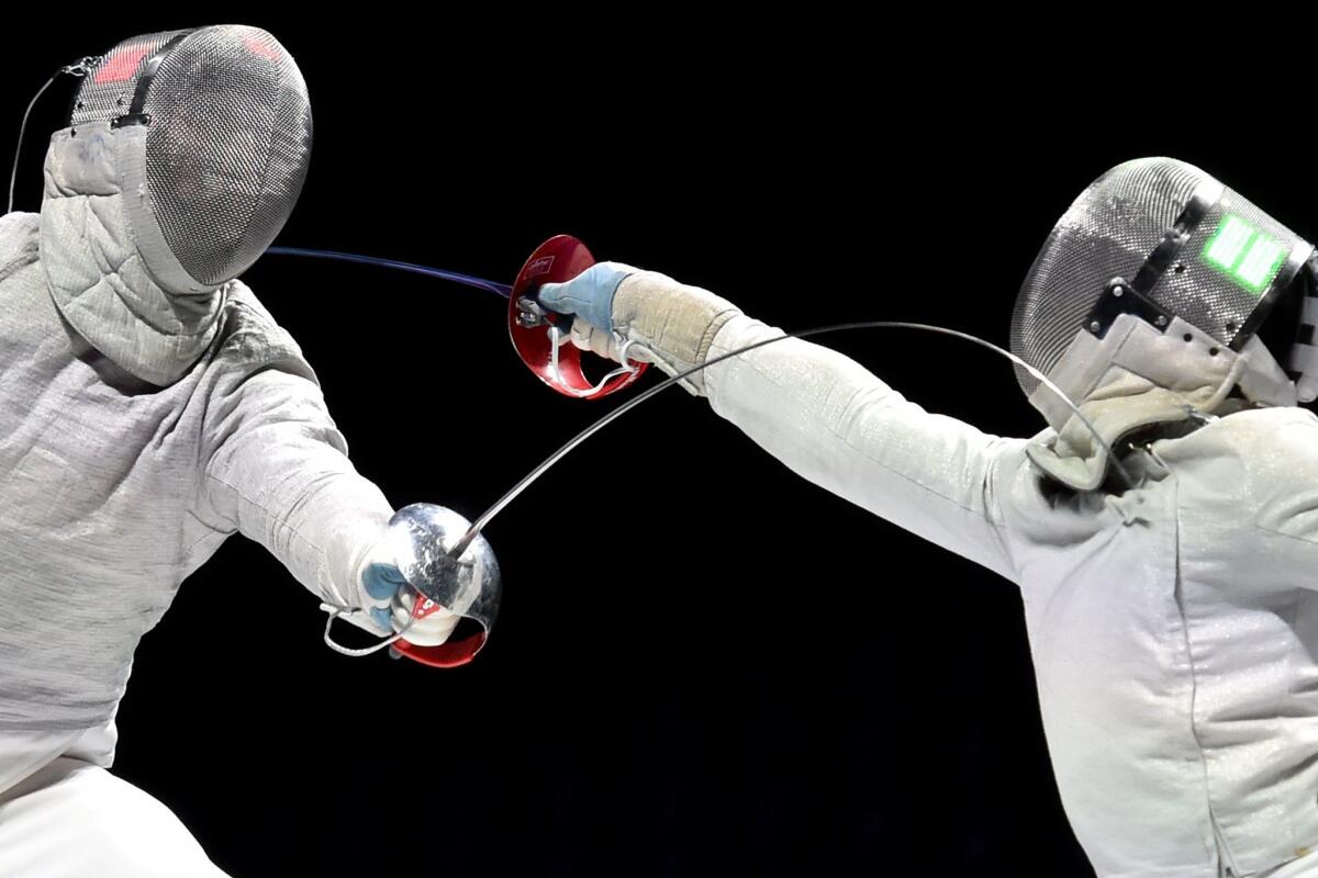 Russia's Alexey Yakimenko, left, and Daryl Homer of the U.S. compete in the men's sabre final at the world fencing championships in Moscow.