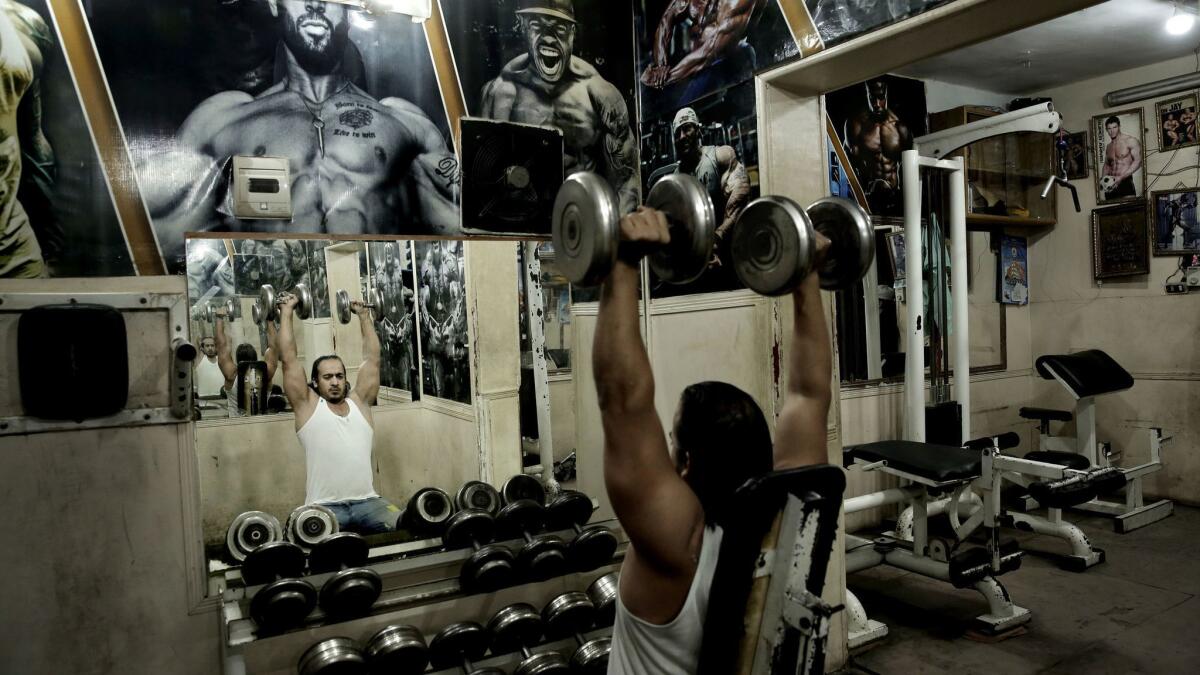 A man lifts weights at a gym in Cairo.